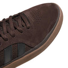 Close-up of the Tyshawn HQ4740 Brown Gum Adidas Skateboarding Suede Shoes with perforated details, brown laces, black leather stripes, and a textured rubber sole—premium skate style.