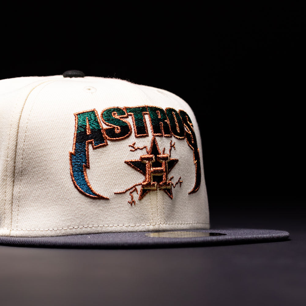 The Undaground 22WS Chrome Houston Astros New Era Hat 5950 Fitted, a white and black fitted cap by New Era, features a bold, colorful embroidered ASTROS logo with a star and H on the front and is displayed against a dark Chrome Undaground backdrop.