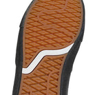 Close-up of the VN000D85CC81 Skate Curren Caples Charcoal Black Vans shoe’s brown suede rubber sole with wavy tread and curved white stripe, featuring black material and durable Duracap underlays for skating.