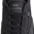 A close-up of the VN000D85CC81 Skate Curren Caples Charcoal Black Vans shows the tongue label, black laces, Vans logo tag, visible stitching, and suede material with durable Duracap underlays for added protection and longevity.