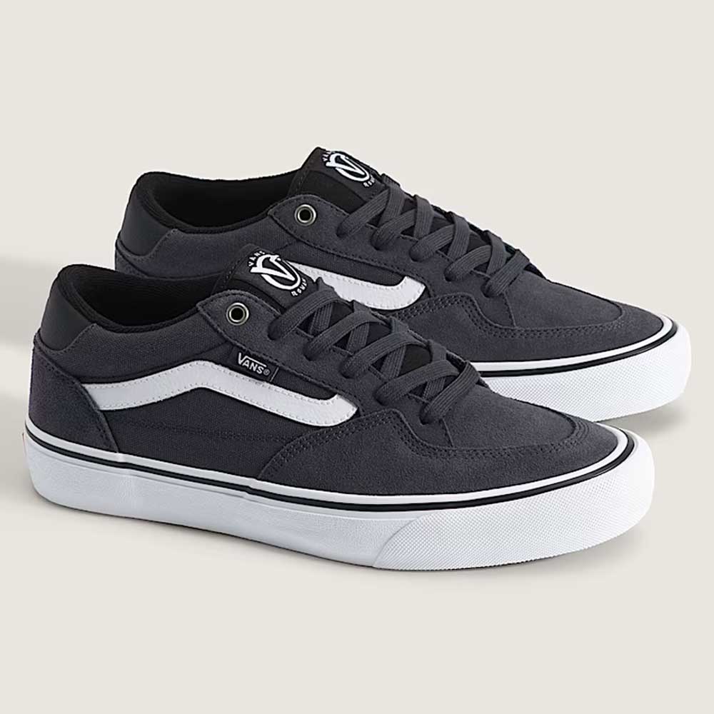 A pair of charcoal gray Vans Rowan VN0A5JICH911 suede sneakers with white soles, white side stripes, and black laces, displayed on a light background—perfectly blending classic style with the durability you expect from a top skate shoe.