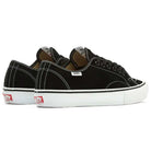 A pair of Vans Skate AVE Classic Black White VN000Y1NBA2 suede skateboard shoes with white stitching, white soles, and a red Vans logo on the heel, featuring DuraCap reinforcements for added durability, positioned side by side and facing slightly away.