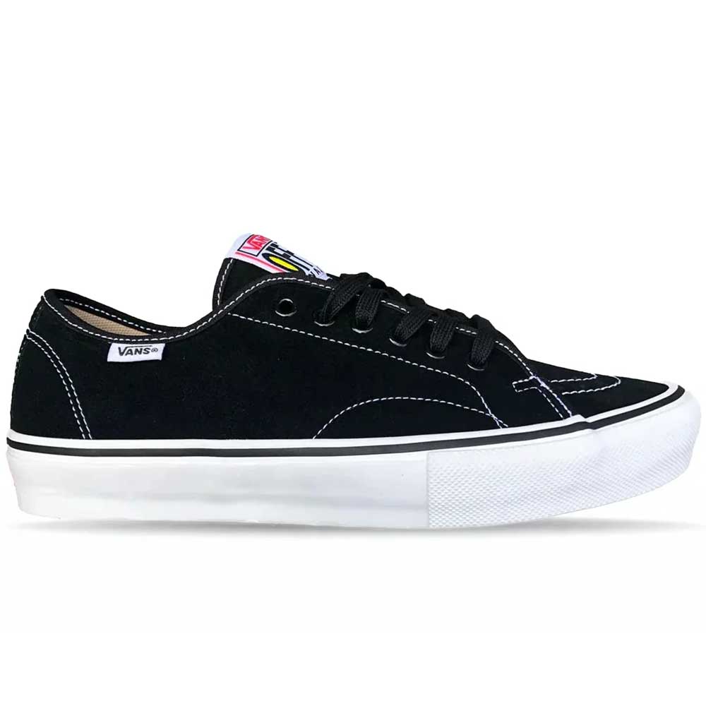 The Vans Skate AVE Classic Black White VN000Y1NBA2 Suede Skateboard Shoe is shown in a side profile on a white background. This black sneaker features white stitching, a white sole, and black laces. The signature Vans logo tag appears on the side, while a colorful label accents the tongue. Constructed with durable DuraCap overlays for enhanced longevity, this shoe blends classic style with skate-ready performance.