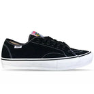 The Vans Skate AVE Classic Black White VN000Y1NBA2 Suede Skateboard Shoe is shown in a side profile on a white background. This black sneaker features white stitching, a white sole, and black laces. The signature Vans logo tag appears on the side, while a colorful label accents the tongue. Constructed with durable DuraCap overlays for enhanced longevity, this shoe blends classic style with skate-ready performance.
