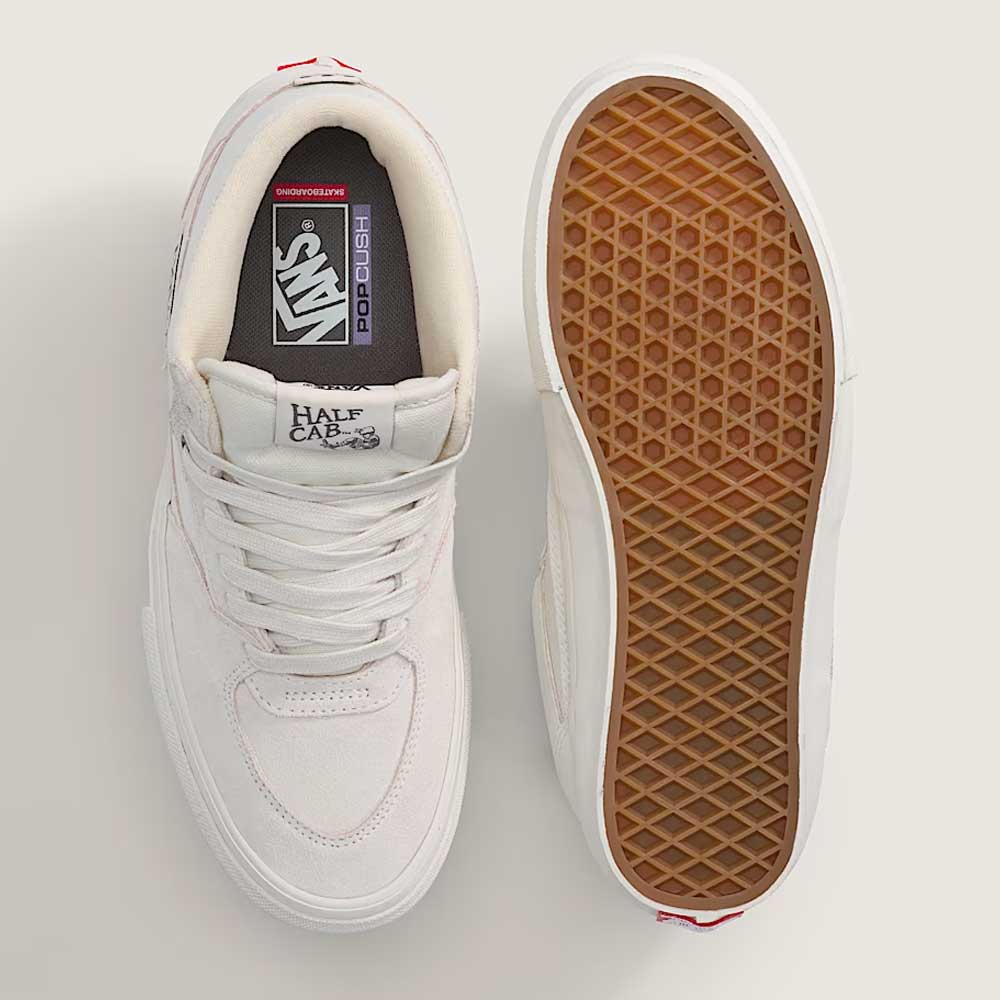 The Vans Skate Half Cab Marshmallow White VN0A5FCDCA Suede Skateboard Shoes are shown—one emphasizes the laces and logos from above, while the other reveals the gum rubber waffle sole with PopCush impact protection.