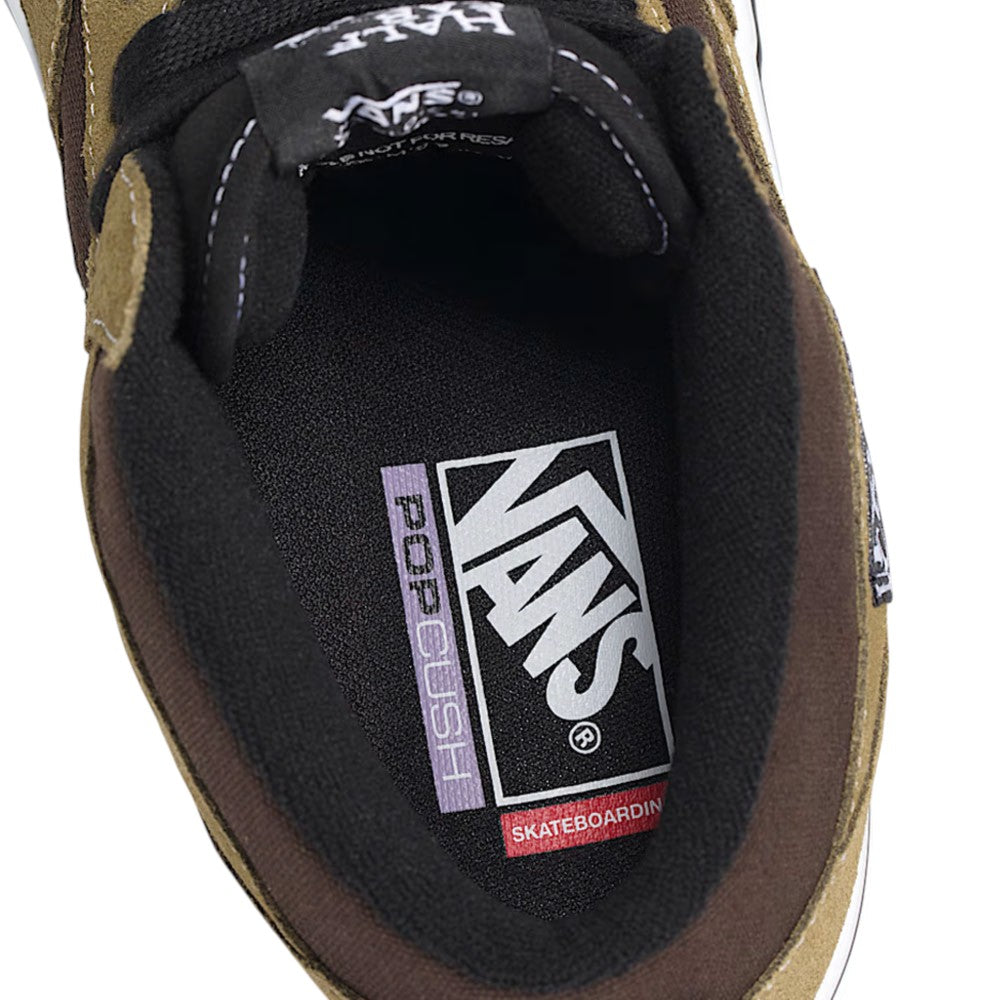 Interior view of an olive brown Vans Skate Half Cab Olive Brown VN0A5FCDOVB Suede Skateboarding Shoes mid-top, showcasing a padded collar and cushioned insole with printed branding for impact protection.