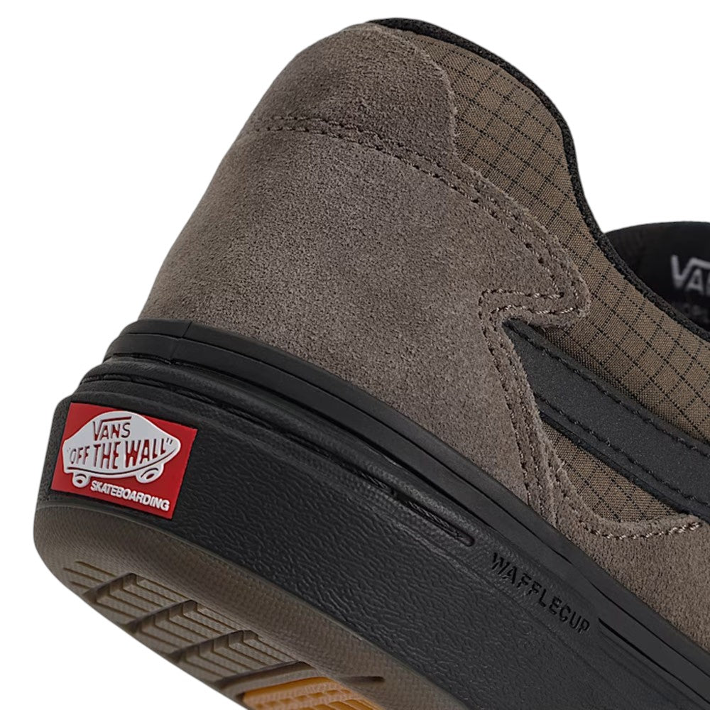 Close-up of the heel of a dark grey Vans Skate Kyle Walker Wafflecup Ripstop Bungee VN000DA49JC Suede Rubber Skateboarding Shoe with a black rubber sole and a red logo patch.