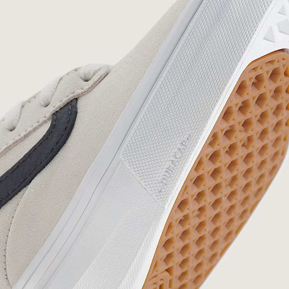 Close-up of the Vans Skate Kyle Walker Wafflecup White Gunmetal VN000DA4XQL1, featuring a beige suede upper with a black stripe, white midsole, and brown waffle-patterned rubber outsole. The sole is embossed with the DURACAP label, while PopCush cushioning provides enhanced comfort and impact protection—ideal for those seeking both style and high performance.