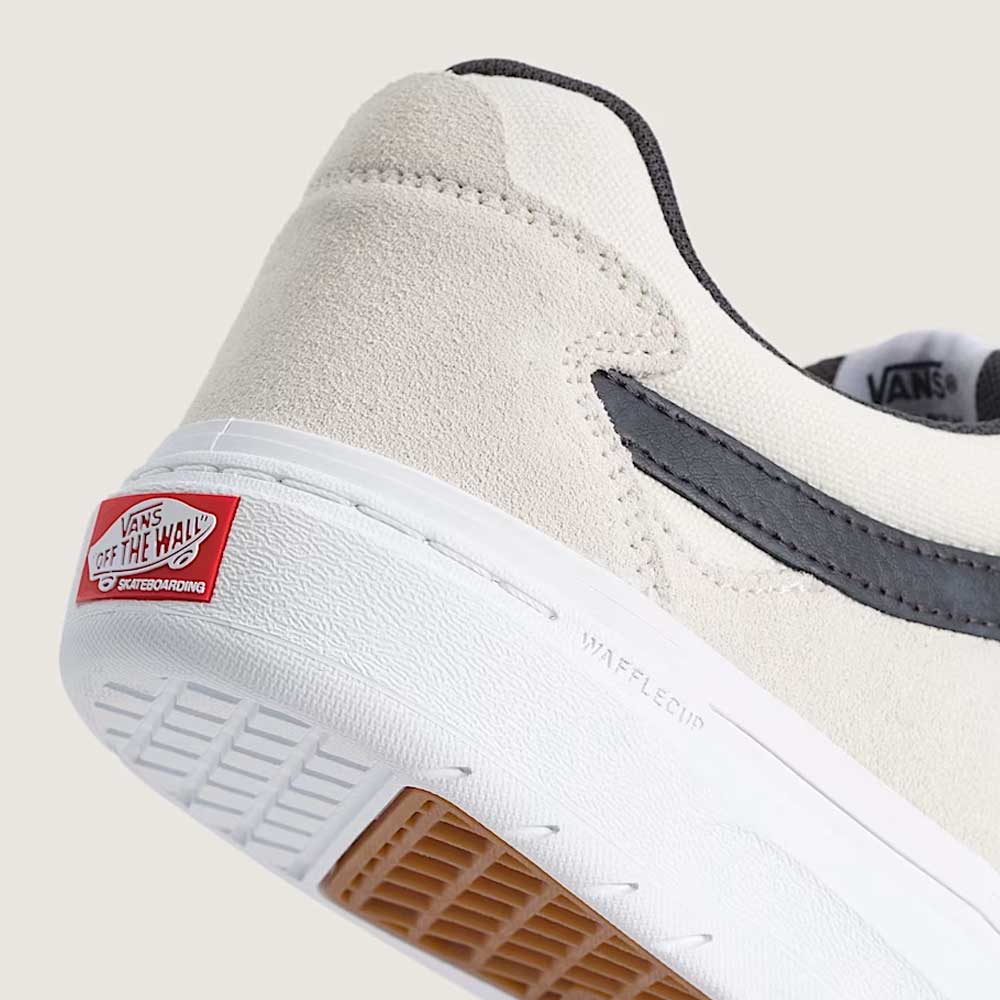 Close-up of the heel of the Vans Skate Kyle Walker Wafflecup White Gunmetal (VN000DA4XQL1) suede and rubber shoe, featuring a black stripe, white sole, and red “Vans Off The Wall” logo on the back. The textured sole displays WAFFLECUP branding and includes PopCush cushioning inspired by Kyle Walker’s signature style.