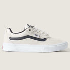 The Vans Skate Kyle Walker Wafflecup White Gunmetal VN000DA4XQL1 Suede Rubber Shoes are beige skate shoes designed in collaboration with Kyle Walker, featuring a black stripe, white sole, and black detailing. Displayed from the side against a plain light background, this model incorporates PopCush technology for enhanced comfort and impact protection.