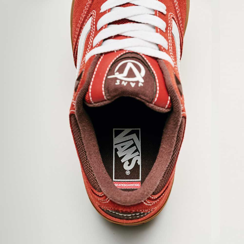 Top view of Vans Skate Rowan Z3 VN000V74BRD Gum Bordeaux Suede skateboard shoe with white laces, visible Vans logo on tongue and insole, plus partially visible gum sole at the bottom for impact protection.