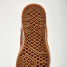 Close-up of the Vans Skate Rowan Z3 VN000V74BRD Gum Bordeaux Suede shoe's sole, showing gum-colored rubber with geometric tread for grip and impact protection; red and white upper edge visible.