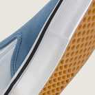 Close-up of the Vans Skate Slip On VN000EG5DSB1 Dusty Blue Suede Shoes’ sole, featuring a gum waffle pattern, white midsole, and light blue suede upper. The word DURACAP is embossed near the edge of the sole—an essential reinforcement feature that enhances durability and skateboarding performance.