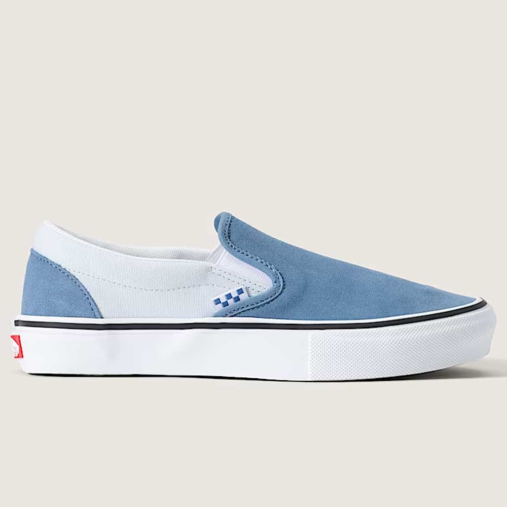 Introducing the Vans Skate Slip On VN000EG5DSB1 Dusty Blue Suede Shoes—a skateboarding shoe in blue and white suede, featuring a white sole, black trim, and a subtle blue checkerboard pattern near the elastic side panels. Designed for durability and skate performance with a striking red accent on the heel, this stylish slip-on is shown against a plain light background.