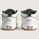 A pair of Vans Skate Half Cab Walnut Gum VN0A5FCD77J1 suede skateboard shoes shown from the back, each heel featuring "Una" above the Vans Off the Wall logo on the sole, perfect for sessions with PopCush impact protection.