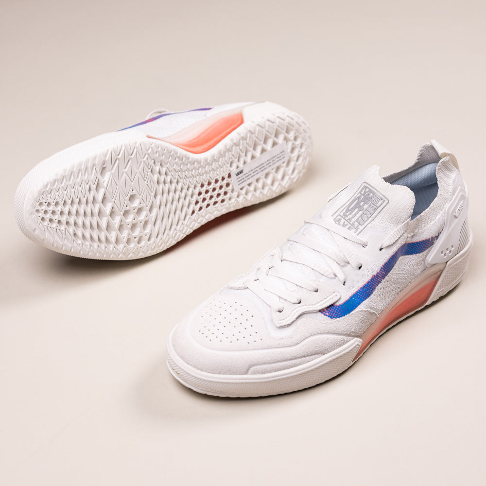 The Vans Skate Ave 2.0 White Blue Knit Suede Shoes (VN000CBUZ5D1) feature white uppers with perforated toes, white laces, gray tongue, blue and pink gradient side details, and a partially translucent orange UltimateWaffle sole.