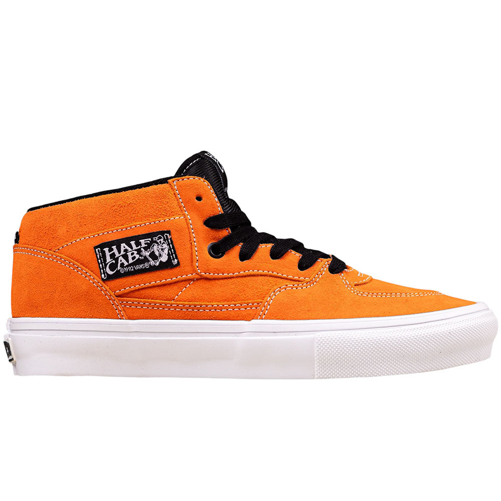 The Skate Half Cab Flame White VN0A5FCDSFZ1 Vans Suede Skate Shoe features an orange suede upper, black laces, white sole, DuraCap reinforcement, and a side patch label reading "Half Cab" with a cartoon graphic.