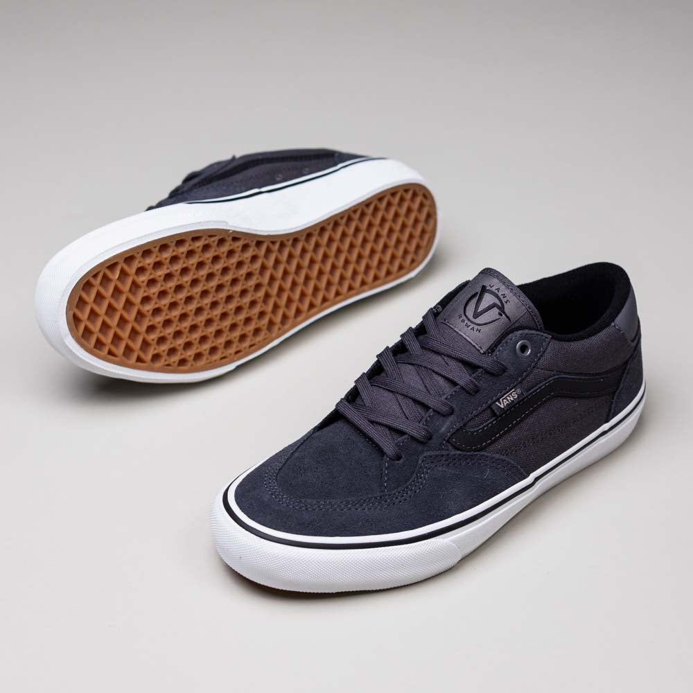 A pair of Skate Rowan Asphalt White VN0A5JICRP9 Suede Rowan Vans Shoes: one upright to show the top and side, the other tilted to reveal the brown waffle-patterned sole of this classic skate shoe.