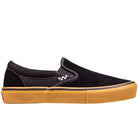 The Vans Skate Slip On VN000EG5B9K1 Black Gum Suede Shoes feature white stitching, a subtle checkerboard pattern, and a thick gum sole—built for durability and ideal for skateboarders seeking long-lasting footwear.