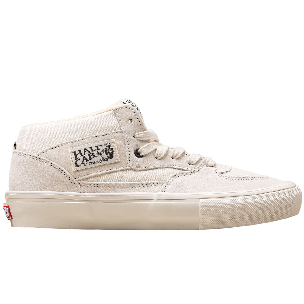The Vans Skate Half Cab Marshmallow White VN0A5FCDCA features a beige mid-top suede upper, white laces, a side Half Cab logo patch, and PopCush impact protection, shown on a white background.
