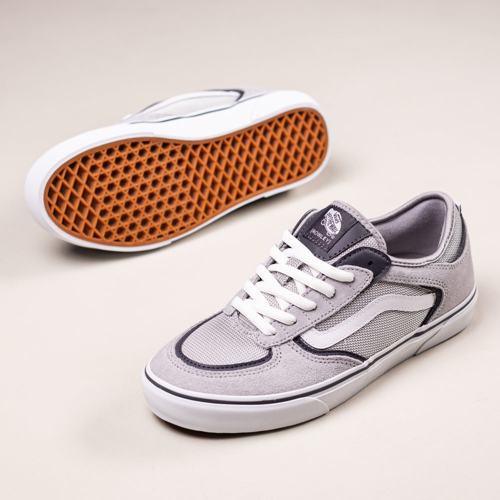 A pair of VN000DA25TC1 Skate Rowley Multi Vans Suede Skateboarding Shoes in gray and white, featuring white laces and gum waffle-pattern soles; one shoe is upright, the other shows the sole.