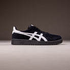 A Japan Pro Asics Black White 1201A92001 suede skateboarding shoe featuring a black upper, white logo, and detailing, shown side-on against a neutral background.