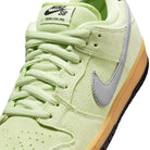 Close-up of Nike SB Verdugo Mountain Dunk Low Pro HQ1626300 in Light Liquid Lime/Wolf Grey/Black, featuring suede texture, pale blue swoosh, light green laces and tongue, and a light brown rubber sole.