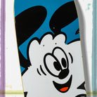 A close-up of the Verdy Vick 8.5 Real Skateboard Deck Skateshop Day featuring a cartoon black-and-white character with big eyes, floppy ears, and an orange tongue on a blue background.