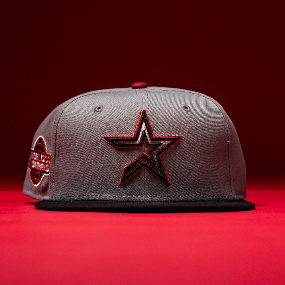 Days B4 WS05 Misty Black Houston Astros New Era 59FIFTY fitted hat, featuring a gray crown with a Misty Black brim, a large outlined Astros star logo on the front, and a side patch, displayed against a red background.