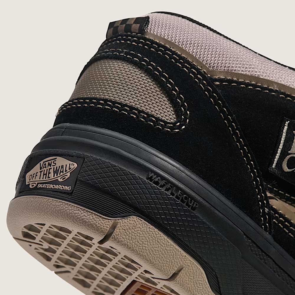 Close-up of the heel of the Vans Wafflecup Half Cab Black Peyote VN000D9ZOUK1 suede skate shoe, showing Off The Wall logo on the sole, black and beige panels, WaffleCup construction, and textured materials.