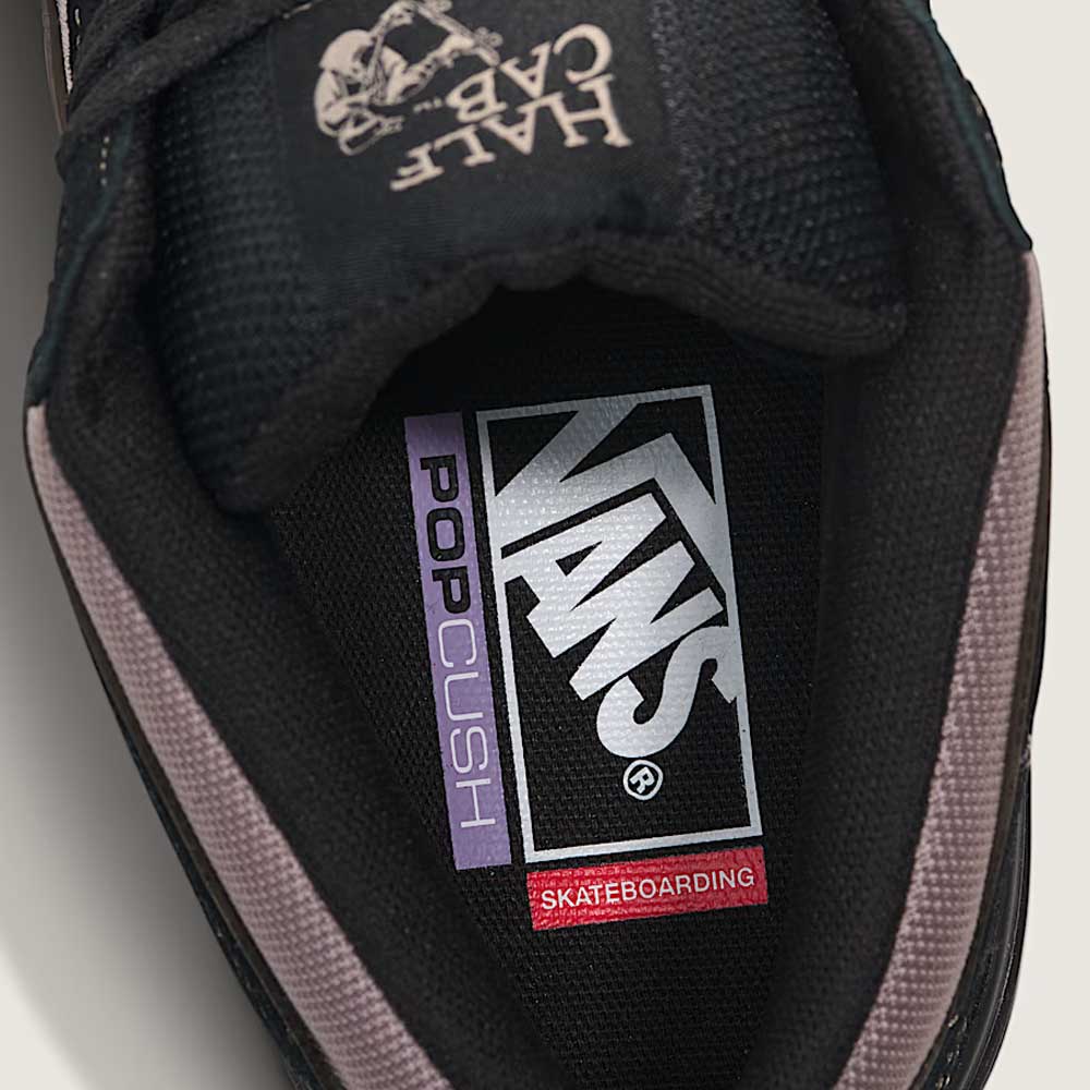 Close-up of the Vans Wafflecup Half Cab Black Peyote VN000D9ZOUK1 suede skate shoe, showing the insole with white, purple, and red Vans PopCush Skateboarding branding on a black background.