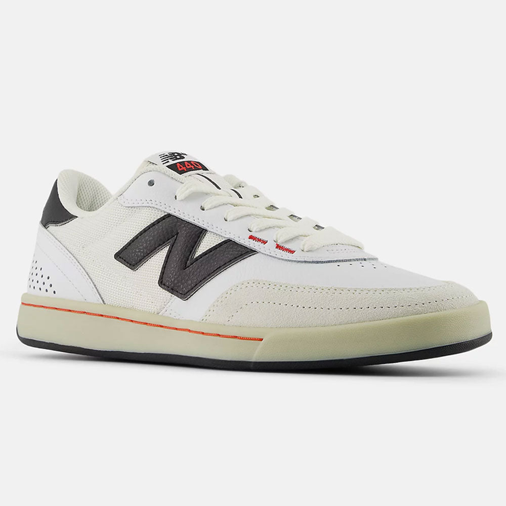 The White Black 440 NO2 New Balance Numeric Suede Skateboarding Shoes feature a durable white upper, black accents, a bold black N logo, beige ABZORB midsole sole, and subtle red detail near the laces, shown angled on a plain background.