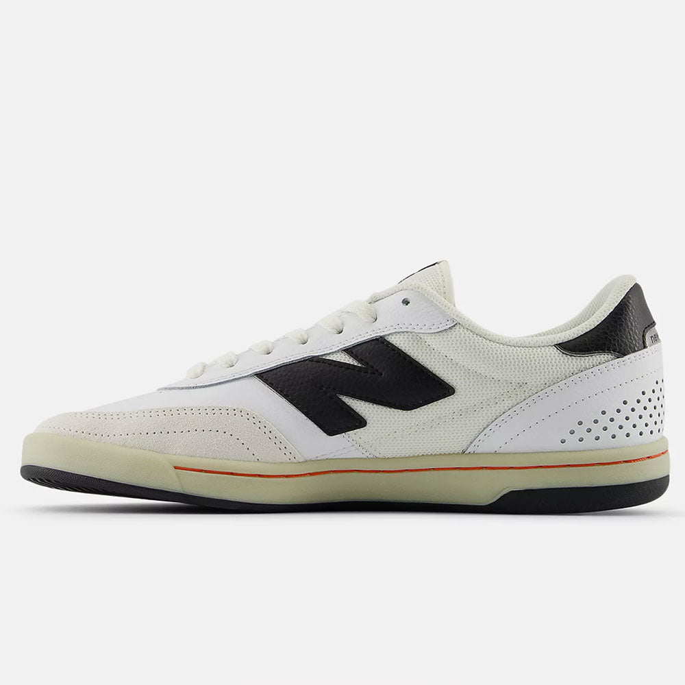 The White Black 440 NO2 New Balance Numeric Suede Skateboarding Shoes feature a durable white suede upper, black N logo, perforated heel, off-white sole with thin orange stripe and ABZORB midsole, plus a black outsole—shown from the side.
