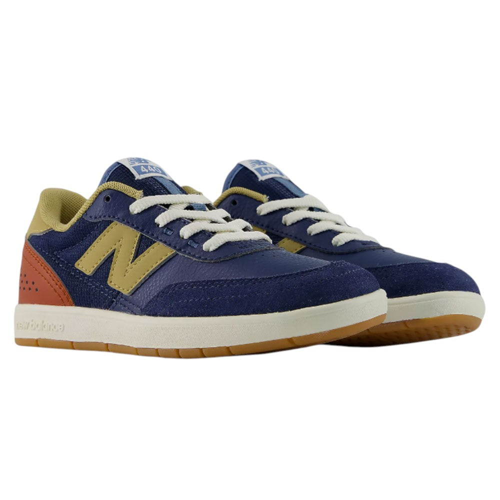 YOUTH 440 NVB New Balance Numeric Suede Skateboarding Shoes in navy blue, yellow, and rust orange feature white laces, gum soles, and the signature N logo on the side. Viewed from a front angle, these durable skate shoes are designed with a reinforced toe cap and sturdy rubber cupsole construction for both style and long-lasting performance.