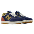 YOUTH 440 NVB New Balance Numeric Suede Skateboarding Shoes in navy blue, yellow, and rust orange feature white laces, gum soles, and the signature N logo on the side. Viewed from a front angle, these durable skate shoes are designed with a reinforced toe cap and sturdy rubber cupsole construction for both style and long-lasting performance.