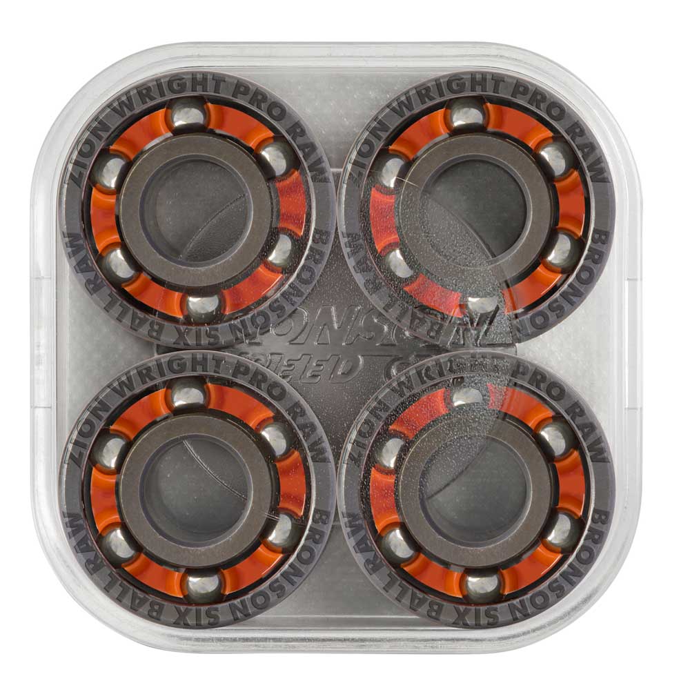 A clear plastic case containing four high-speed Zion Wright Pro 6 Ball RAW Bronson Speed Co. skateboard bearings, featuring orange and black detailing and arranged in a square formation. The shield-free design displays the text “BRONSON WRIGHT PRO RAW” on each bearing, engineered for optimal skate performance by Bronson Speed Co.