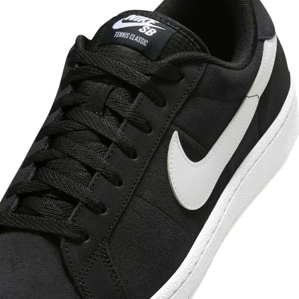 Close-up of the Zoom Tennis Classic HF7386004 Black White Suede Nike SB Skateboarding Shoe, showing its black suede upper, white swoosh logo and sole, black laces, and NIKE SB branding on the tongue.