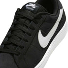 Close-up of the Zoom Tennis Classic HF7386004 Black White Suede Nike SB Skateboarding Shoe, showing its black suede upper, white swoosh logo and sole, black laces, and NIKE SB branding on the tongue.