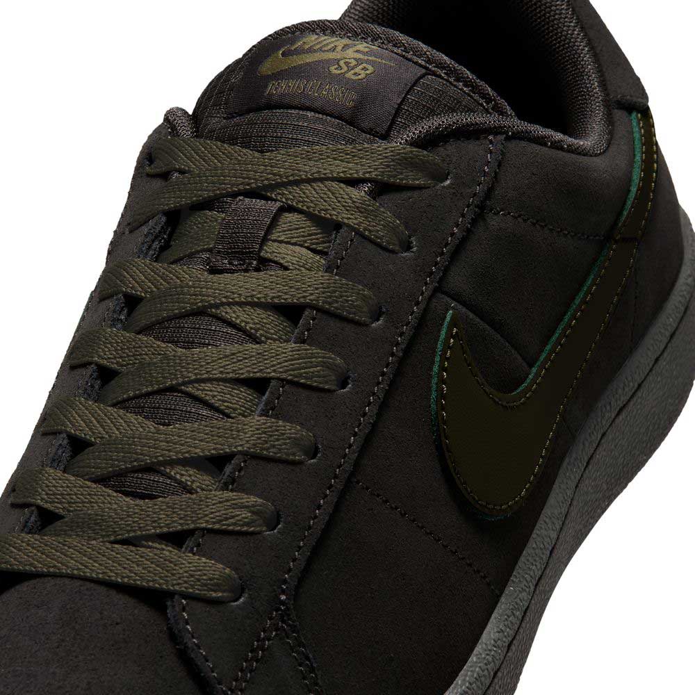 Close-up of the Nike SB Zoom Tennis Classic HF7386200, featuring a deep pewter and medium olive suede upper, olive green laces, black swoosh, and a cushioned insole for skateboarding comfort.