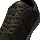 Close-up of the Nike SB Zoom Tennis Classic HF7386200, featuring a deep pewter and medium olive suede upper, olive green laces, black swoosh, and a cushioned insole for skateboarding comfort.