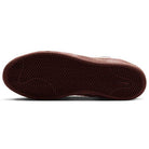 The image shows the brown, textured rubber sole of a Zoom Tennis Classic x Rassvet IO9846400 Blue Void Sail Nike SB Leather Skateboarding Shoe, featuring a herringbone tread pattern and a small Nike swoosh logo near the heel.