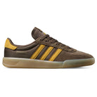 The Daewon Song Glenburn Brown Yellow KZ8777 Adidas Skateboarding Shoes feature a mix of suede and leather in brown and yellow, iconic three yellow stripes, a translucent rubber sole, and DAE 801 along with adidas branding on the side—perfect for anyone after street-ready sneakers with standout style.