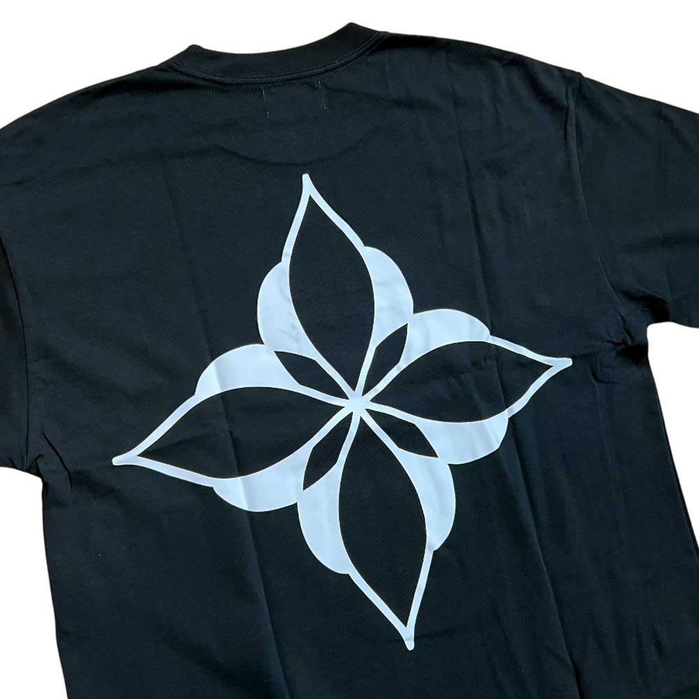 Introducing the Cleo Icon Black Tee—a black t-shirt showcasing a bold, white geometric flower-inspired design with four pointed petals on the back. Expertly crafted for the perfect fit using meticulous cut-and-sew construction, this tee merges contemporary style with superior craftsmanship.