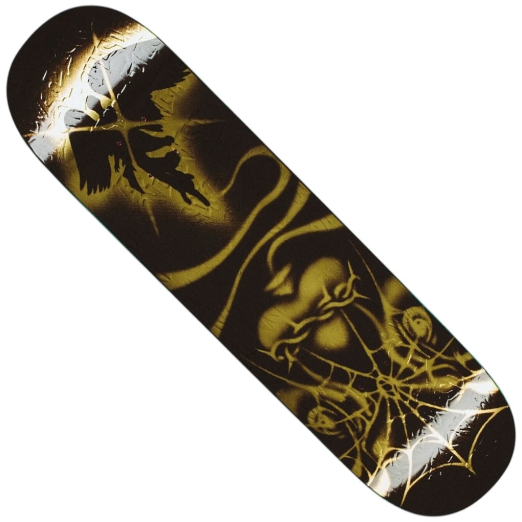 The Curren Caples Genesis 8.25x31.79 FA Deck features gold and black artwork with a heart, spiderweb, roses, and a winged angel—showcasing dramatic flair and edgy Tercer Mundo inspiration from Fucking Awesome.