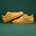 A pair of Nike SB Air Force 1 Flax Black sneakers are stacked against a green background. Enter the READ BELOW the BUTTON RAFFLE at Southside Skatepark for your chance to own this standout style.