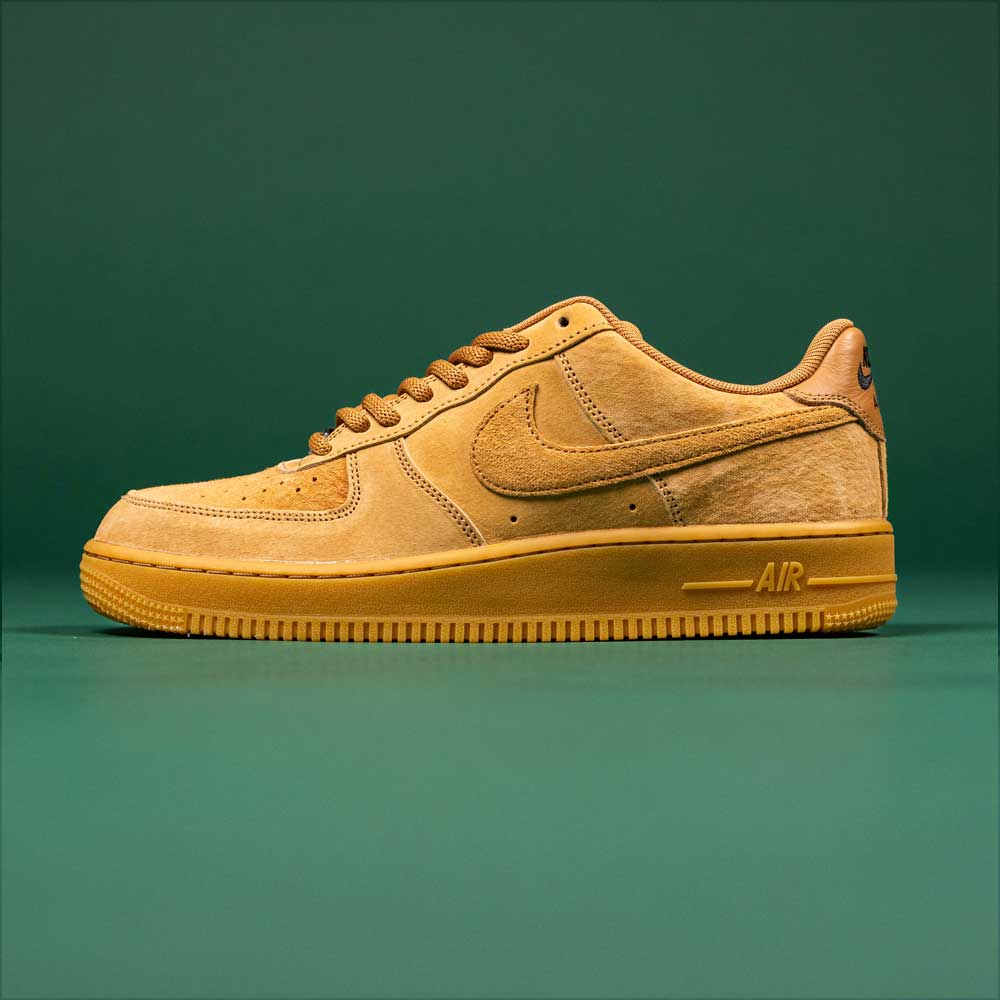 Tan "READ BELOW the BUTTON RAFFLE Nike SB Air Force 1 Flax Black" sneaker with a gum sole shown from the side on a green background. Enter the raffle for this exclusive drop at Southside Skatepark.