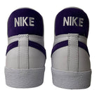 The DZ4949100 Court Purple White Blazer Mid Nike SB Leather Skateboarding Shoes feature a classic design with white and purple leather, and "NIKE" embroidered in white on the purple heel—iconic style for skateboarding.