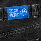 A close-up of Polar Big Boy Jeans Silver Black Denim, featuring a blue patch above the pocket with "BIG BOY" and a face doodle in white. These high waisted jeans combine standout style and comfort.