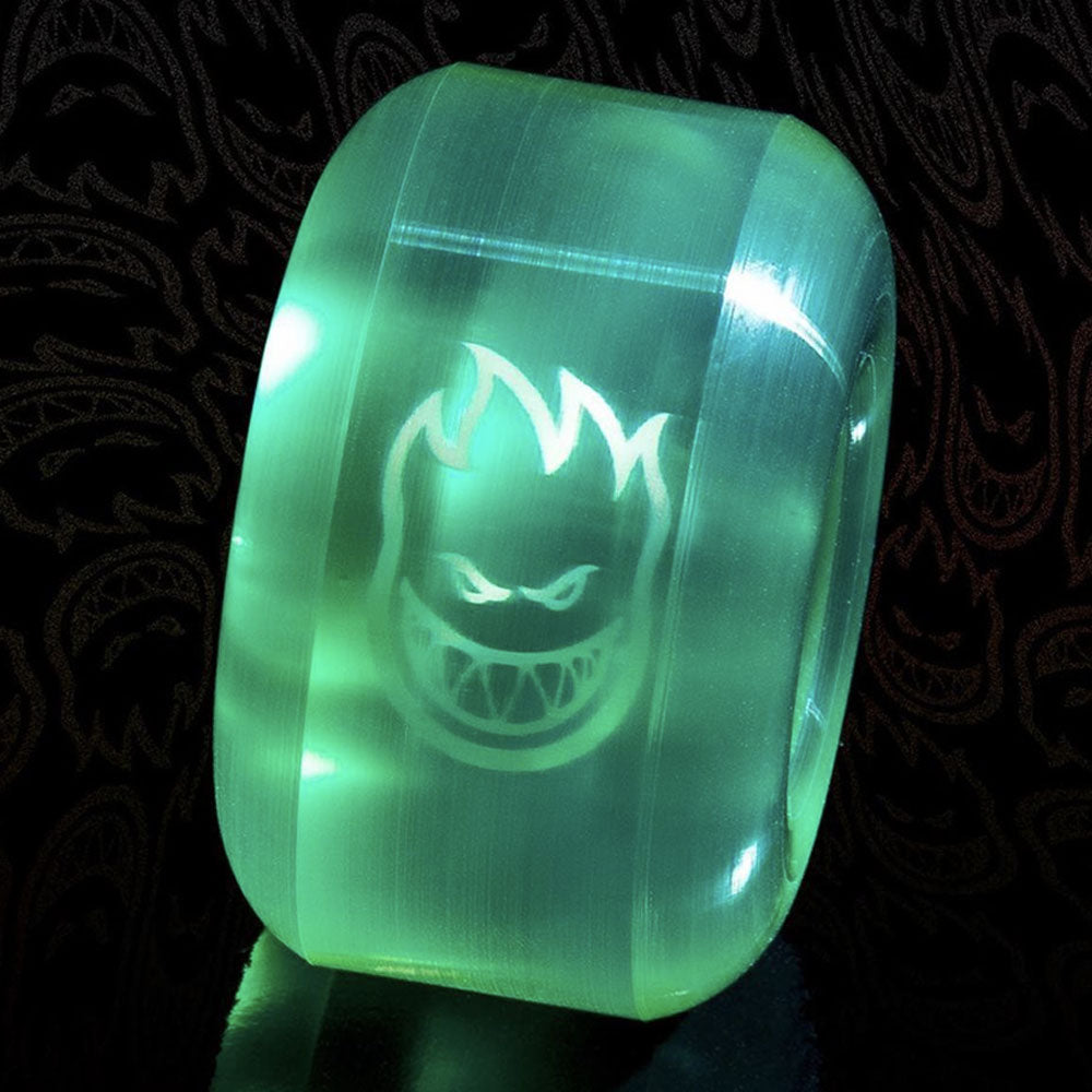 Translucent green 53mm Spitfire Wheels Sapphire 53mm90A Clear Green Conical Full skateboard wheel featuring a flaming skull logo printed on the side.