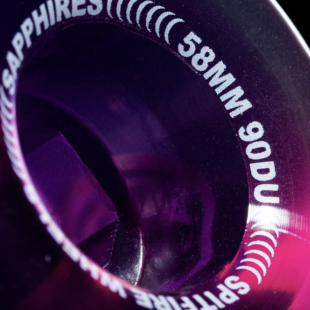 Close-up of a translucent purple Spitfire Wheels Sapphire 58mm90A Clear Purple Conical Full skateboard wheel.